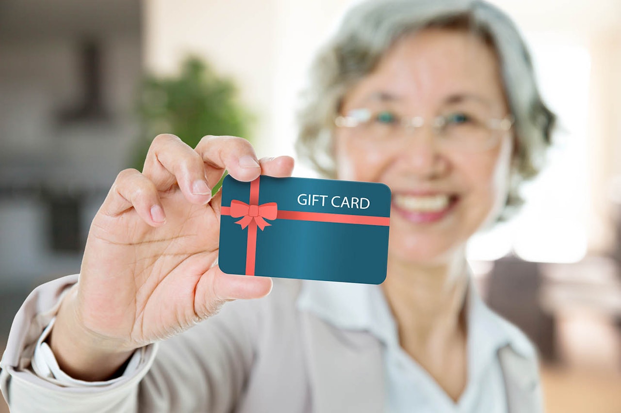 Senior woman with gift card