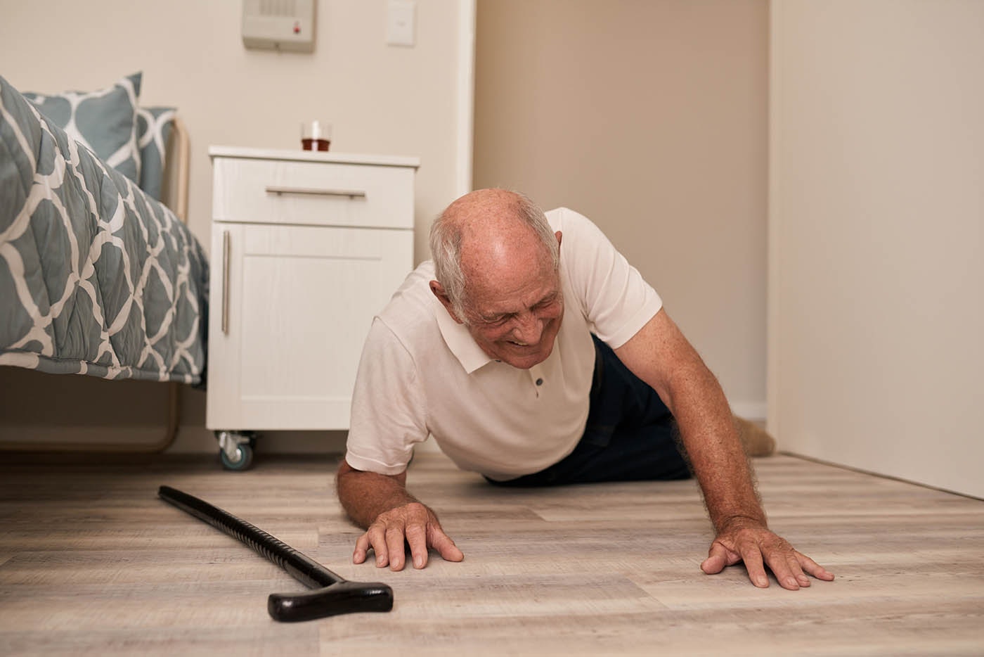 Senior man grimacing in pain after a fall