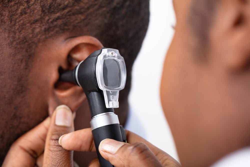 A close up of a patient receiving an ear exam